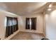 Carpeted bedroom with large window and dark curtains at 634 S Hazel Ct, Denver, CO 80219