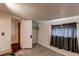 Carpeted bedroom with closet and window with dark curtains at 634 S Hazel Ct, Denver, CO 80219