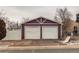 Detached two-car garage with white doors and purple siding at 634 S Hazel Ct, Denver, CO 80219