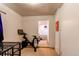 Home gym area with exercise bike and view into a bedroom space at 634 S Hazel Ct, Denver, CO 80219