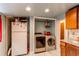 Laundry area equipped with a washer, dryer, and storage space, adding convenience to the home at 634 S Hazel Ct, Denver, CO 80219