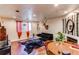 Inviting living room featuring hardwood floors, comfortable seating, and natural light from the window at 634 S Hazel Ct, Denver, CO 80219
