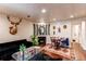 Comfortable living room with a fireplace, dining area, and open layout perfect for entertaining at 634 S Hazel Ct, Denver, CO 80219