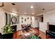 Cozy living room with hardwood floors, a decorative fireplace, and a dining area at 634 S Hazel Ct, Denver, CO 80219