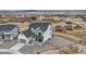 Aerial view of a two-story home with gray roof in a community with a sparse landscape at 555 Coal Bank Trl, Castle Rock, CO 80104