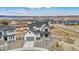 An aerial view showcasing the house surrounded by beautiful scenery and a well-kept landscape at 555 Coal Bank Trl, Castle Rock, CO 80104