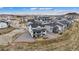 Aerial view of a two-story home with a black roof in a neighborhood with a fenced in yard at 555 Coal Bank Trl, Castle Rock, CO 80104