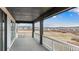 Scenic view from the home's balcony with white railings, overlooking a grassy landscape and houses in the distance at 555 Coal Bank Trl, Castle Rock, CO 80104