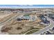 Aerial view showcases community amenities: a clubhouse, pool, and tennis courts enhance the neighborhood lifestyle at 555 Coal Bank Trl, Castle Rock, CO 80104