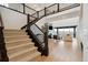 The light foyer features hardwood floors, a grand staircase with an open-concept living area at 555 Coal Bank Trl, Castle Rock, CO 80104