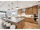 Spacious kitchen boasts a large island, modern appliances, and beautiful wood cabinets at 555 Coal Bank Trl, Castle Rock, CO 80104