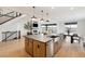 Open-concept kitchen showcases an island with bar seating and view of the living area at 555 Coal Bank Trl, Castle Rock, CO 80104