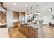Well-equipped kitchen island with modern appliances, generous counter space, and open staircase at 555 Coal Bank Trl, Castle Rock, CO 80104