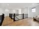 Upstairs landing with hardwood floors and dark railings, leading to additional rooms at 555 Coal Bank Trl, Castle Rock, CO 80104