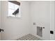 Bright laundry room features star-patterned tile floors, a window and modern connections at 555 Coal Bank Trl, Castle Rock, CO 80104