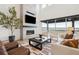 Spacious living room featuring a cozy fireplace, modern decor, and natural light at 555 Coal Bank Trl, Castle Rock, CO 80104
