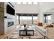 Bright living room with fireplace, large windows, and cozy furniture with great views at 555 Coal Bank Trl, Castle Rock, CO 80104