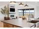 Bright living room featuring a fireplace, large windows, and seamless flow with the kitchen at 555 Coal Bank Trl, Castle Rock, CO 80104