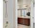 Bathroom features a dual sink vanity with dark wood cabinets and modern lighting at 226 N Millbrook St, Aurora, CO 80018