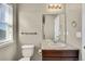 Bathroom featuring a vanity with sink, toilet, towel bar, and bright natural light at 226 N Millbrook St, Aurora, CO 80018