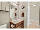 Cozy half-bathroom with a classic vanity, neutral tones, and decorative wall accents at 226 N Millbrook St, Aurora, CO 80018