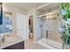 Bright bathroom featuring a walk-in shower with glass door and a double sink vanity at 226 N Millbrook St, Aurora, CO 80018