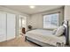 Cozy bedroom featuring carpeted floors, natural light, and an ensuite bathroom at 226 N Millbrook St, Aurora, CO 80018