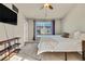 Bedroom featuring a fan, carpeted floors, and bright windows at 226 N Millbrook St, Aurora, CO 80018