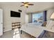 Bright bedroom featuring a fan, TV, and carpeted floors at 226 N Millbrook St, Aurora, CO 80018