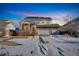 Charming two-story home featuring a three-car garage, stone accents, and a welcoming front porch at dusk at 226 N Millbrook St, Aurora, CO 80018