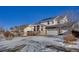 Charming two-story home featuring a three-car garage, stone accents, and a welcoming front porch at 226 N Millbrook St, Aurora, CO 80018