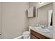 Neat half bathroom featuring a modern vanity, granite countertop, and decorative accents at 226 N Millbrook St, Aurora, CO 80018