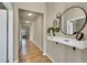 Inviting hallway with hardwood floors, decorative mirrors, and a stylish console table at 226 N Millbrook St, Aurora, CO 80018