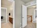 Hallway leading to the bathroom, which features a vanity with sink and wood cabinets at 226 N Millbrook St, Aurora, CO 80018