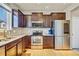 Kitchen featuring stainless steel appliances, wood cabinets, and plenty of counter space at 226 N Millbrook St, Aurora, CO 80018