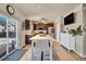 Well-lit kitchen with stainless appliances, dark wood cabinets, and an eat-in kitchen table at 226 N Millbrook St, Aurora, CO 80018