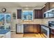 Well-lit kitchen with stainless steel appliances, granite countertops, and a view of the backyard at 226 N Millbrook St, Aurora, CO 80018