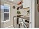 The laundry room offers storage shelves and cabinets at 226 N Millbrook St, Aurora, CO 80018