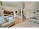 Bright and airy living room open to the kitchen with hardwood floors and comfortable seating at 226 N Millbrook St, Aurora, CO 80018