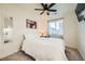 Bright bedroom with ceiling fan, a comfortable bed, and a well-lit window at 7024 Kali Ct, Frederick, CO 80530