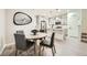 Bright dining area flows into a modern kitchen with gray cabinets and stainless steel appliances at 7024 Kali Ct, Frederick, CO 80530