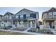 Attractive townhomes featuring stone and siding, a covered porch, and landscaped front yards at 7024 Kali Ct, Frederick, CO 80530