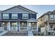 Charming townhome with stone accents, a covered porch, and tidy landscaping at 7024 Kali Ct, Frederick, CO 80530