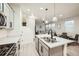 Bright kitchen with a center island, stainless appliances, and a view into the living area at 7024 Kali Ct, Frederick, CO 80530