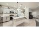 Modern kitchen featuring grey cabinets, stainless steel appliances, and a large island at 7024 Kali Ct, Frederick, CO 80530