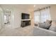 Comfortable living room with a gray sectional sofa, TV, entertainment center, and carpet at 7024 Kali Ct, Frederick, CO 80530