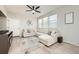 Bright living room with a ceiling fan, a large sectional couch, and ample natural light at 7024 Kali Ct, Frederick, CO 80530