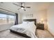 Relaxing main bedroom featuring a ceiling fan, a large window, and a neutral color palette at 7024 Kali Ct, Frederick, CO 80530