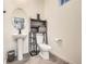 Stylish powder room features pedestal sink, gray storage shelving, and modern fixtures at 7024 Kali Ct, Frederick, CO 80530