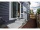Backyard patio with sliding glass door into dining area, wood fence, and dark siding at 17600 Rose Heath Ln, Parker, CO 80134